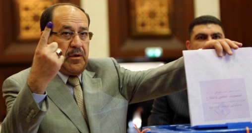 Iraqi Prime Minister Nuri al-Maliki shows his ink-stained finger as he casts his vote in Iraq's first parliamentary election since US troops withdrew at a polling station in Baghdad's fortified Green Zone, on April 30, 2014. Iraqis streamed to voting centres nationwide, amid the worst bloodshed in years, as Maliki seeks reelection. AFP PHOTO / ALI AL-SAADI        (Photo credit should read ALI AL-SAADI/AFP/Getty Images)