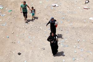 Thousands of Iraqis flee Mosul as militants attack. Photograph by Emrah Yorulmaz/Anadolu Agency/Getty.