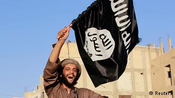 An ISIS fighter celebrates at a parade in Syria's northern Raqqa province