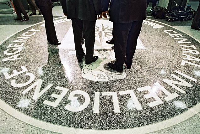 President George W. Bush and CIA Director George Tenet stand on the agency’s seal at CIA headquarters in Langley, Va.