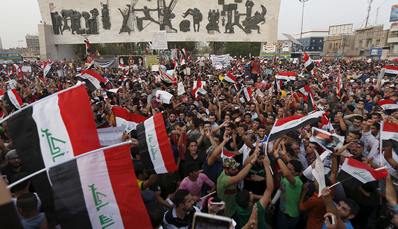 People shout slogans during a demonstration against corruption and poor services regarding power cuts and water shortages at Tahrir Square in central Baghdad, Aug. 7, 2015. 