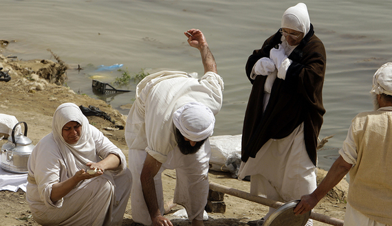 A Sabian Mandaean woman prepares food to mark Eid al-Khalqeh, or Creation of the World, on the banks of the Tigris River in Baghdad